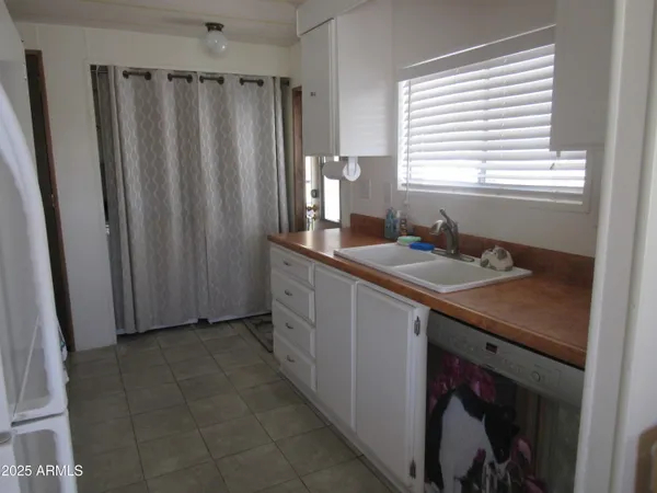a kitchen with sink cabinets and window