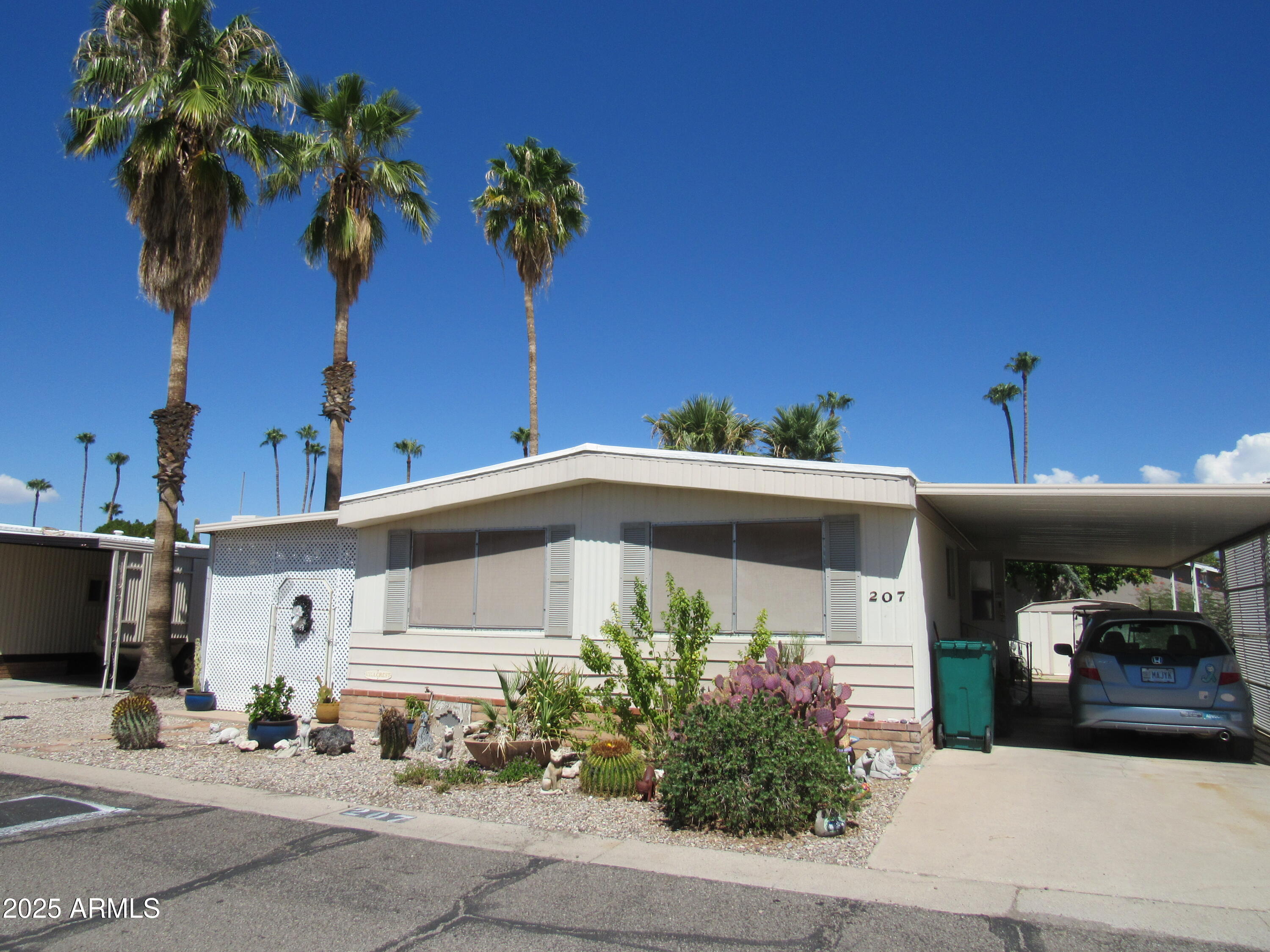 3411 South Camino Seco, Unit 207 Tucson, AZ 85730 - Photo 2 of 25 a front view of a house with a yard