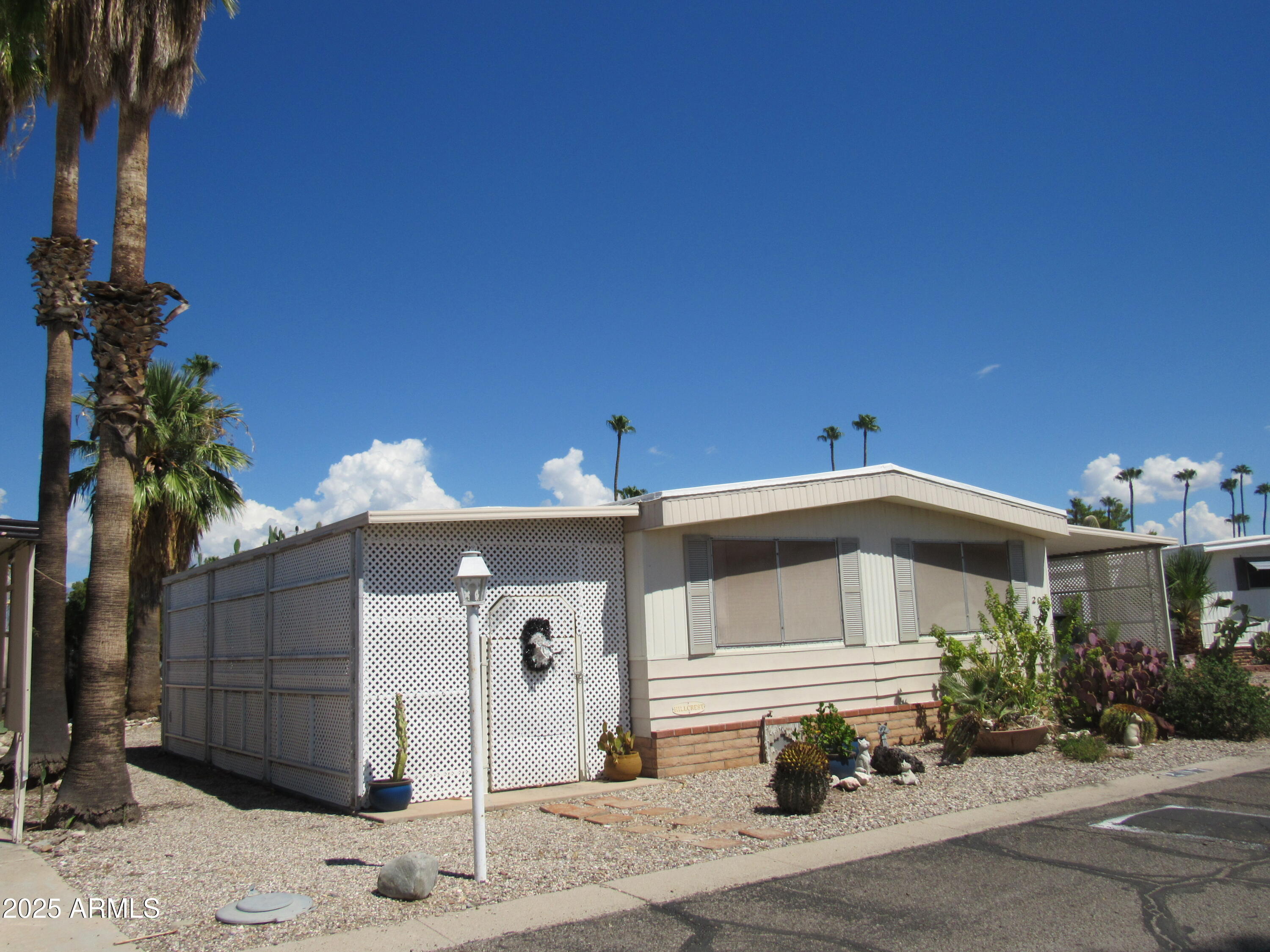 3411 South Camino Seco, Unit 207 Tucson, AZ 85730 - Photo 3 of 25 a front view of a house with a yard