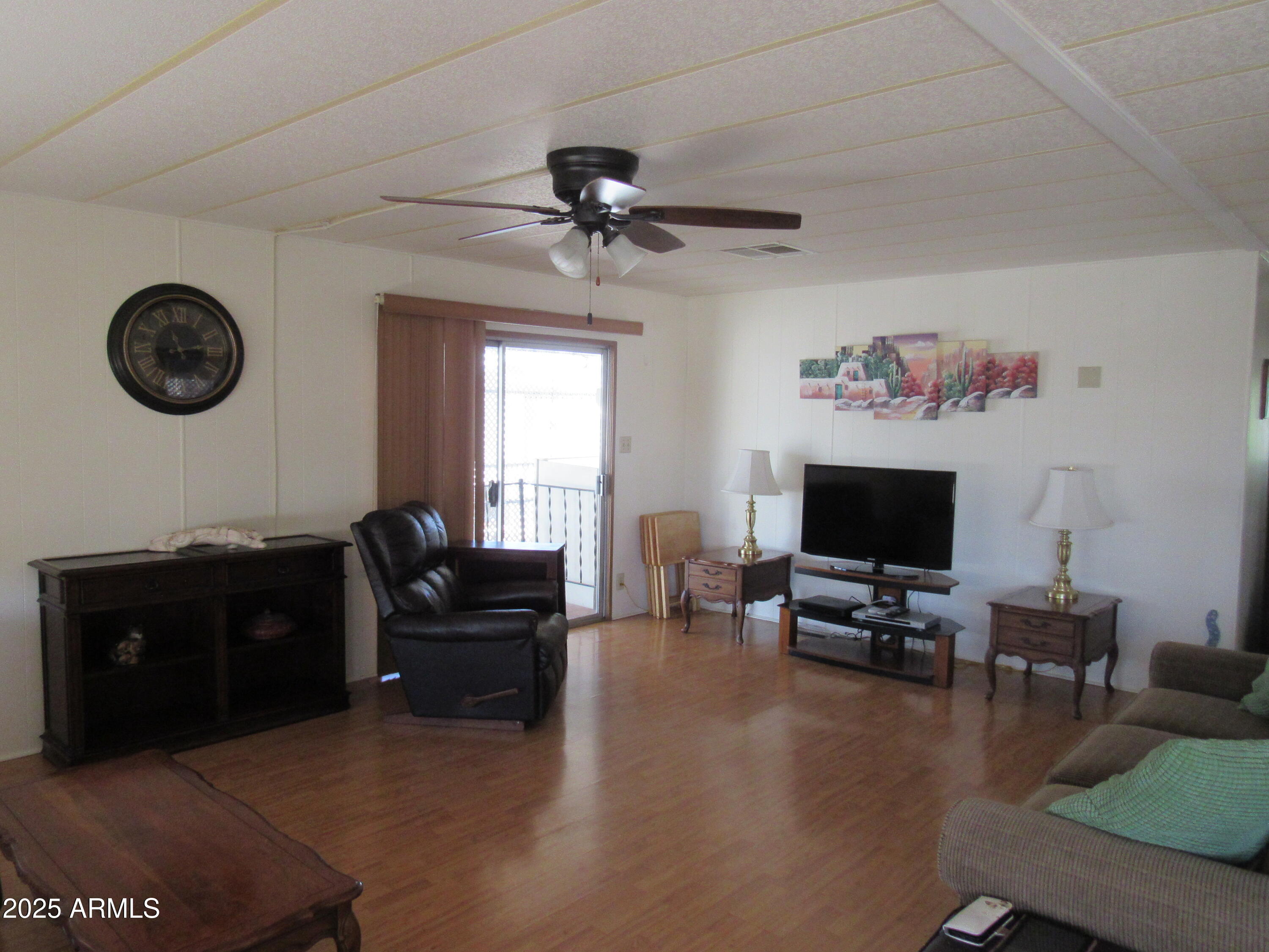 3411 South Camino Seco, Unit 207 Tucson, AZ 85730 - Photo 9 of 25 a living room with furniture and a flat screen tv