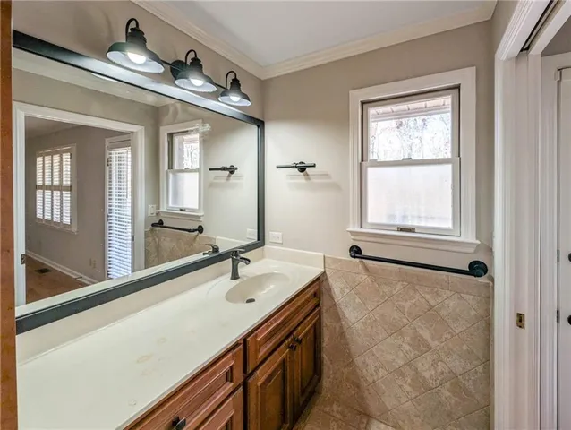 a bathroom with a sink toilet vanity and shower
