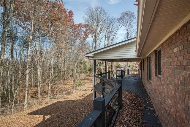 a view of a house with wooden deck front of house
