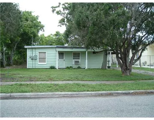 a front view of a house with a yard and a garage