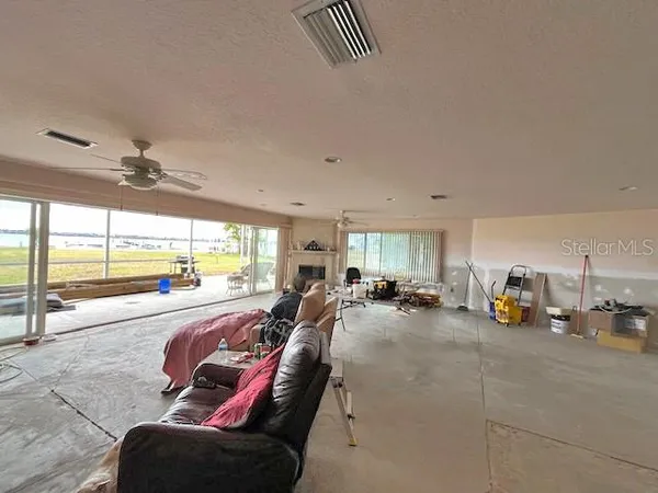 a view of a living room with furniture and floor to ceiling window