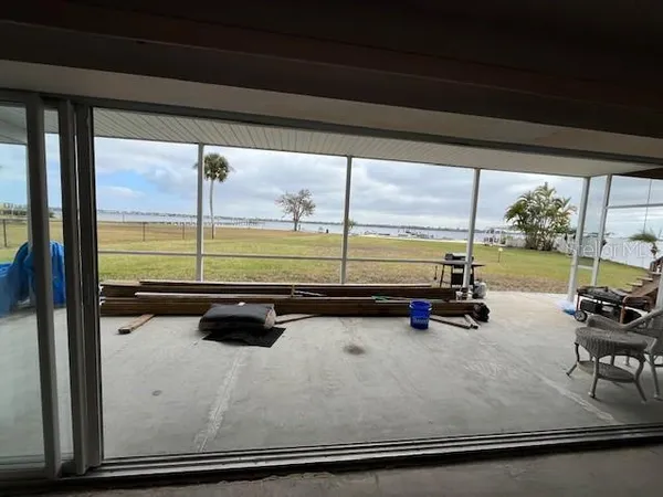 a view of a room with wooden floor and furniture