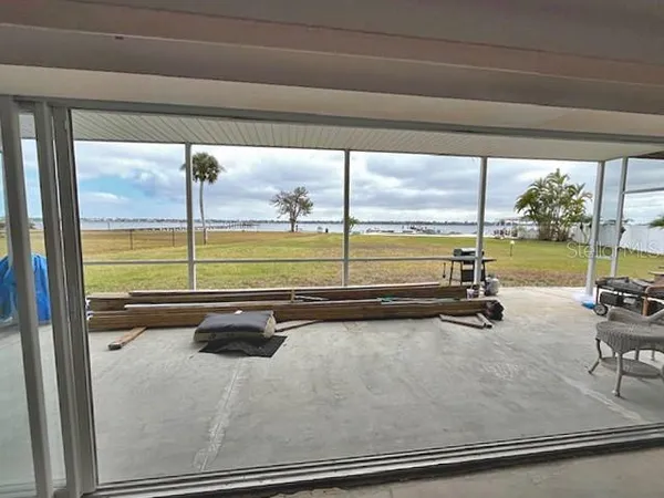 a living room with furniture a fireplace and a large window