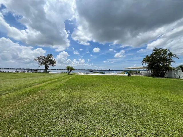 a view of swimming pool with outdoor seating and yard in back