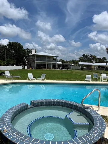 a view of a backyard with sitting area