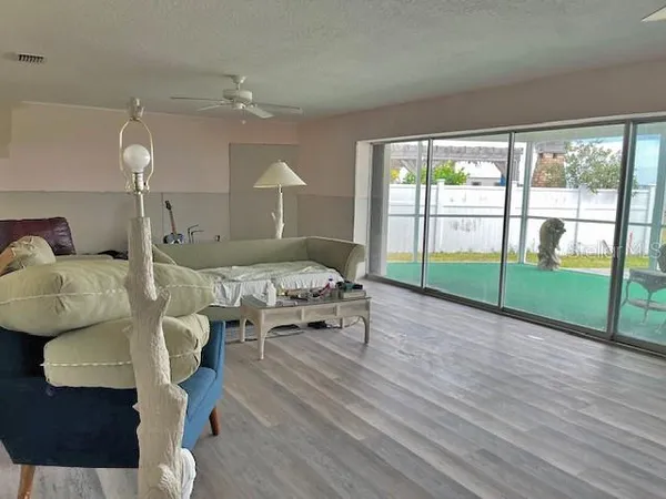 a dining room with furniture and a large window