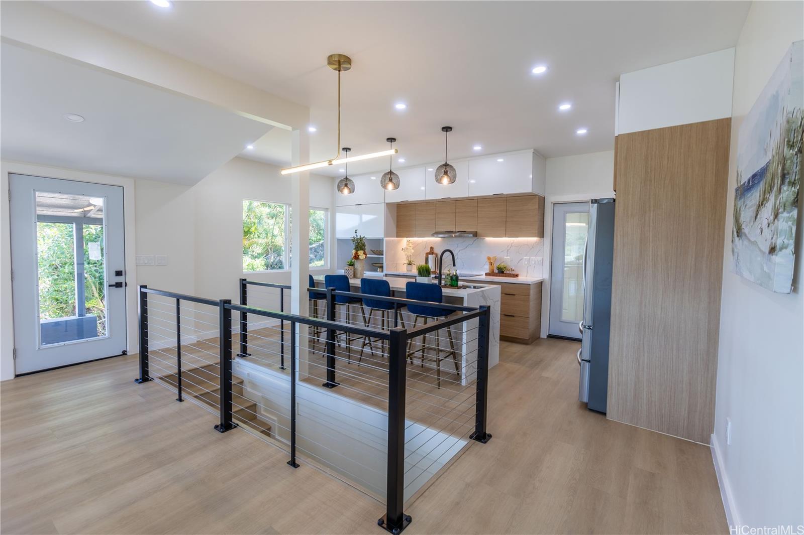 2520 Booth Road Honolulu, HI 96813 - Photo 1 of 1 a kitchen with stainless steel appliances granite countertop a refrigerator a sink dishwasher a stove and a dining table with wooden floor