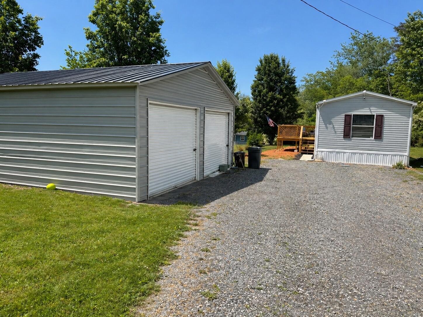 145 Rogers Road Birchwood, TN 37308 - Photo 17 of 21 a view of a house with a backyard and a garage