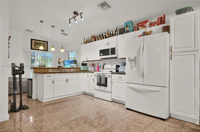 a bedroom with two beds and a window