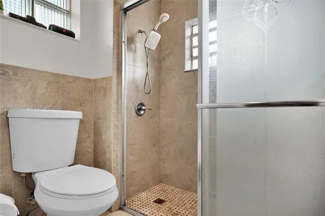 a living room with furniture a dining table a rug and a window