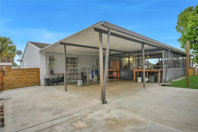 a view of a backyard with plants and outdoor seating