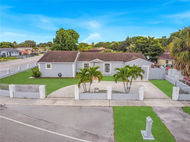 a house with green field in front of it