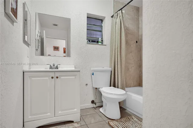 a bathroom with a bath tub with a shower curtain