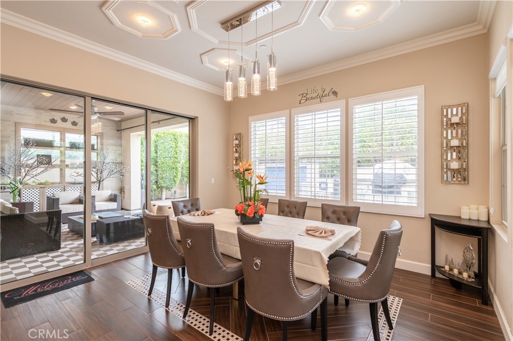 126 Nickel Irvine, CA 92618 - Photo 15 of 59 a dining room with wooden floor a chandelier a glass table and chairs