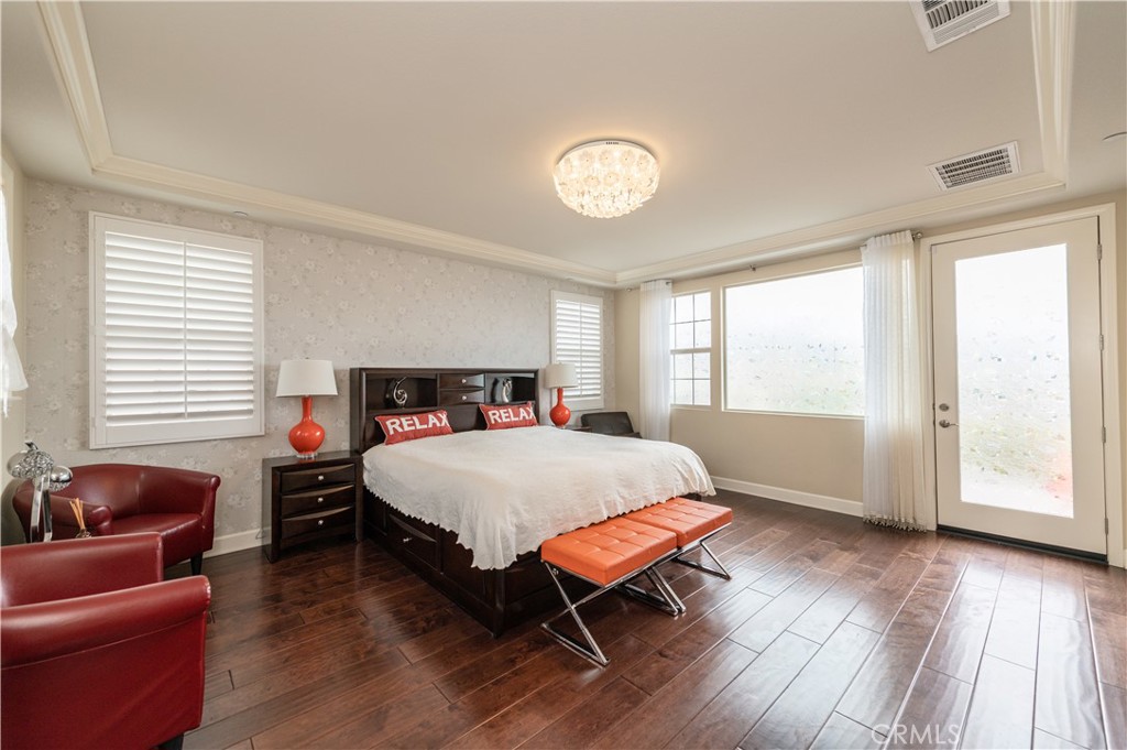 126 Nickel Irvine, CA 92618 - Photo 48 of 59 a spacious bedroom with a bed and wooden floor