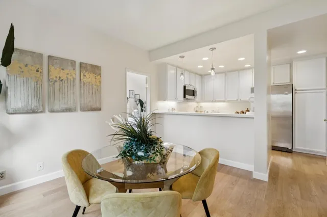 a dining room filled chandelier and wooden floor