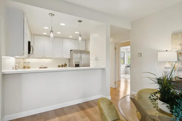 a kitchen with a sink a refrigerator and a counter top space