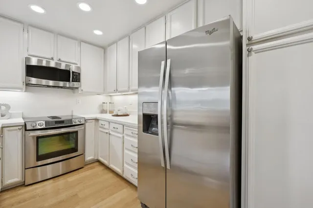 a kitchen with a refrigerator stove and microwave
