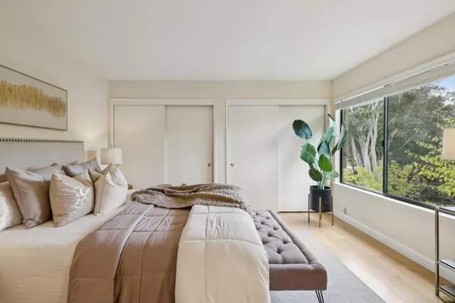 a bed sitting in a bedroom next to a window