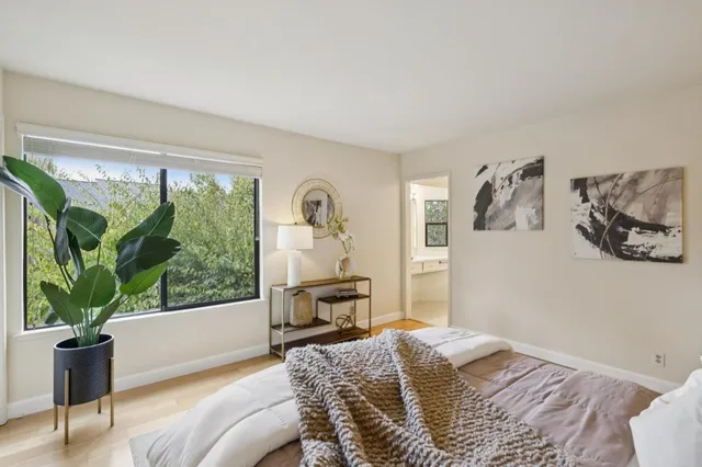 a bedroom with furniture and a potted plant