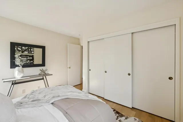 a bedroom with a bed and a table in it