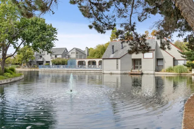 a view of a lake with houses in the back