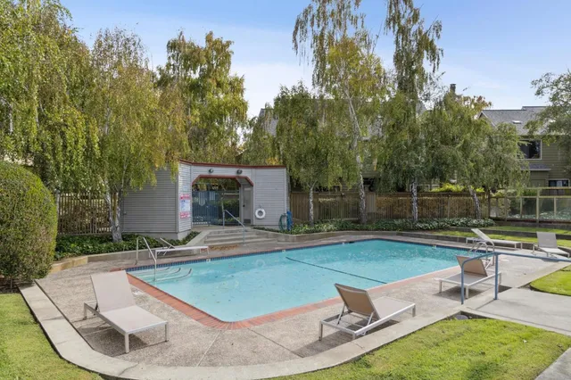 a tree in front of a white house