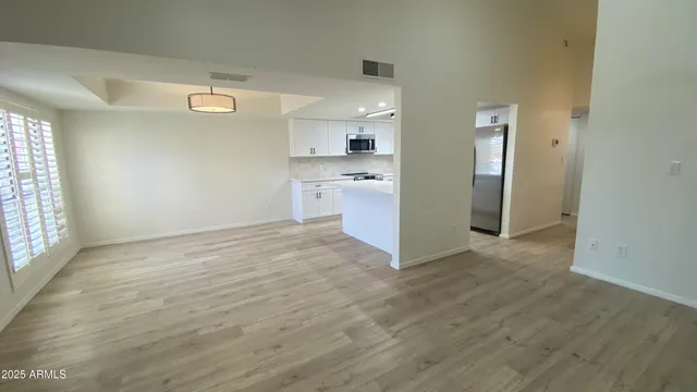a view of a kitchen with a sink and a refrigerator