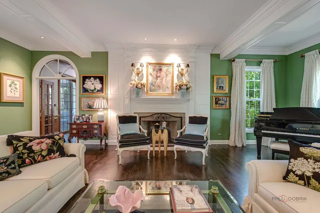 a living room with furniture large window and fireplace