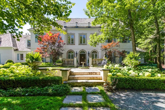 a front view of a house with a yard table and chairs