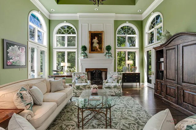 a kitchen with stainless steel appliances granite countertop a refrigerator and a view of living room