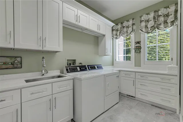 a living room with furniture a wooden floor and next to a window
