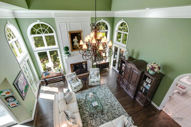 a living room with furniture a flat screen tv and gym equipment