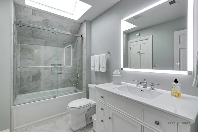 a patio with sofas fire pit table and chairs