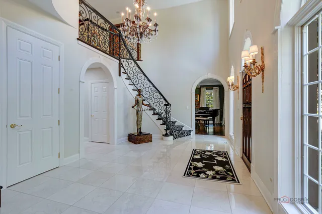 a living room with fireplace furniture and a large window