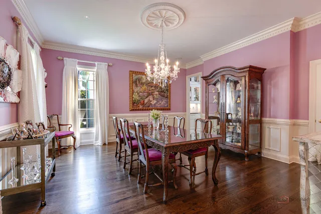 a living room with patio furniture and a chandelier