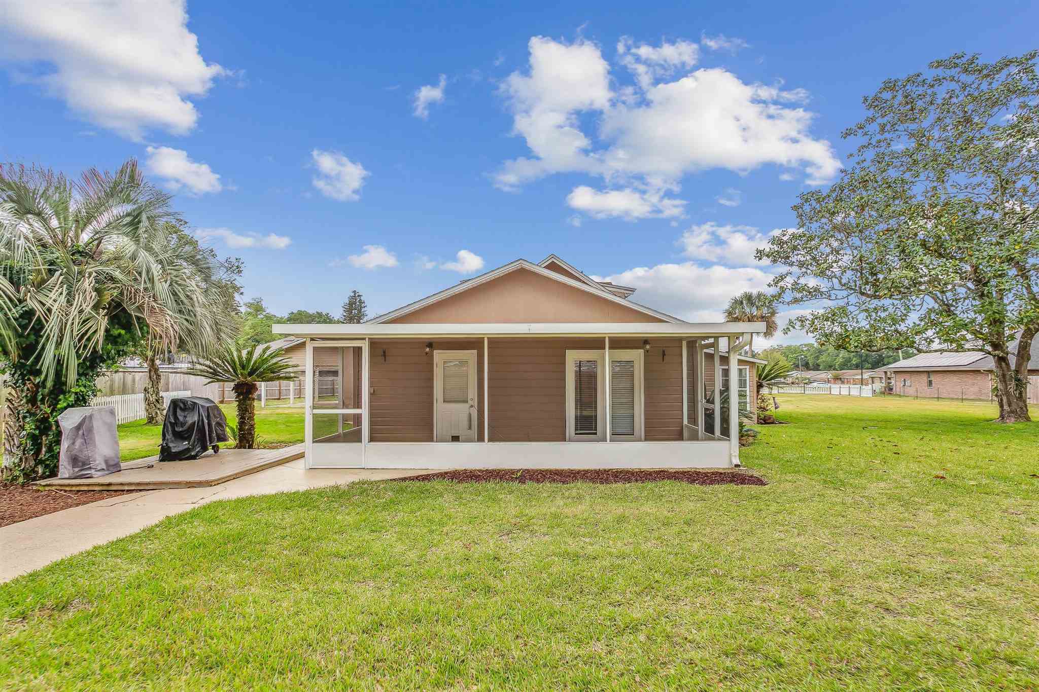5926 Saufley Pines Road Pensacola, FL 32526 - Photo 29 of 35 a view of a house with a yard and potted plants