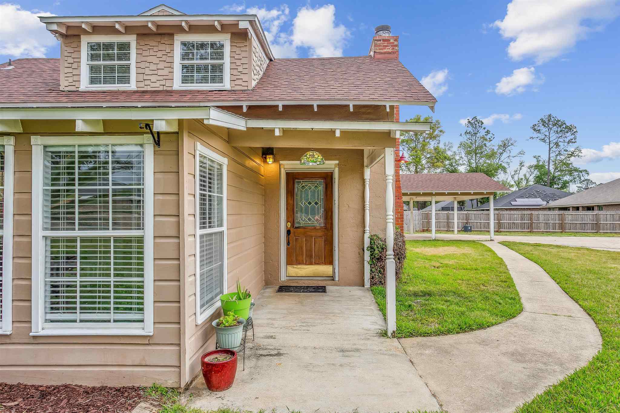 5926 Saufley Pines Road Pensacola, FL 32526 - Photo 3 of 35 a front view of a house with a garden