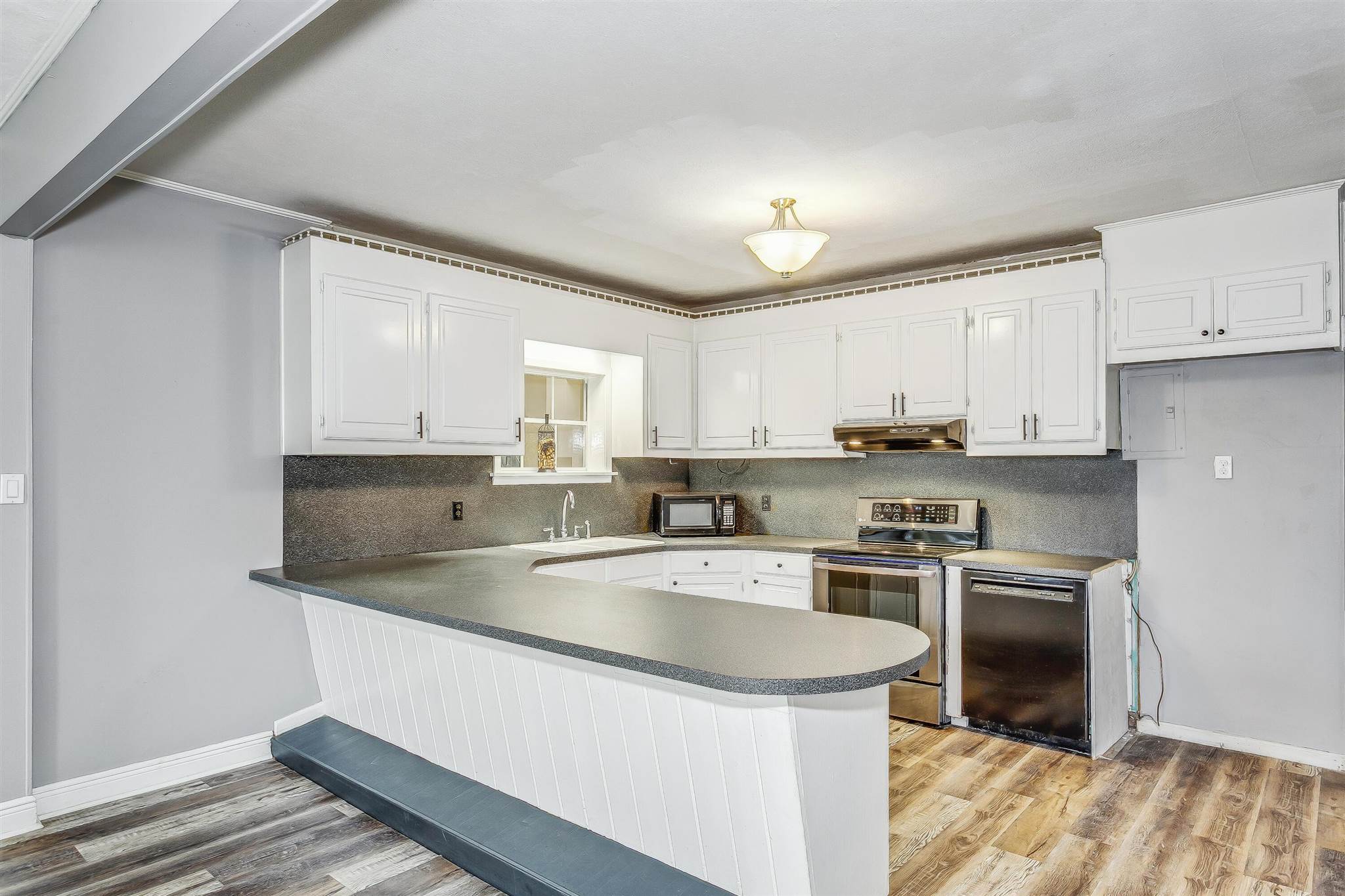 5926 Saufley Pines Road Pensacola, FL 32526 - Photo 9 of 35 a kitchen with stainless steel appliances granite countertop a sink stove and refrigerator