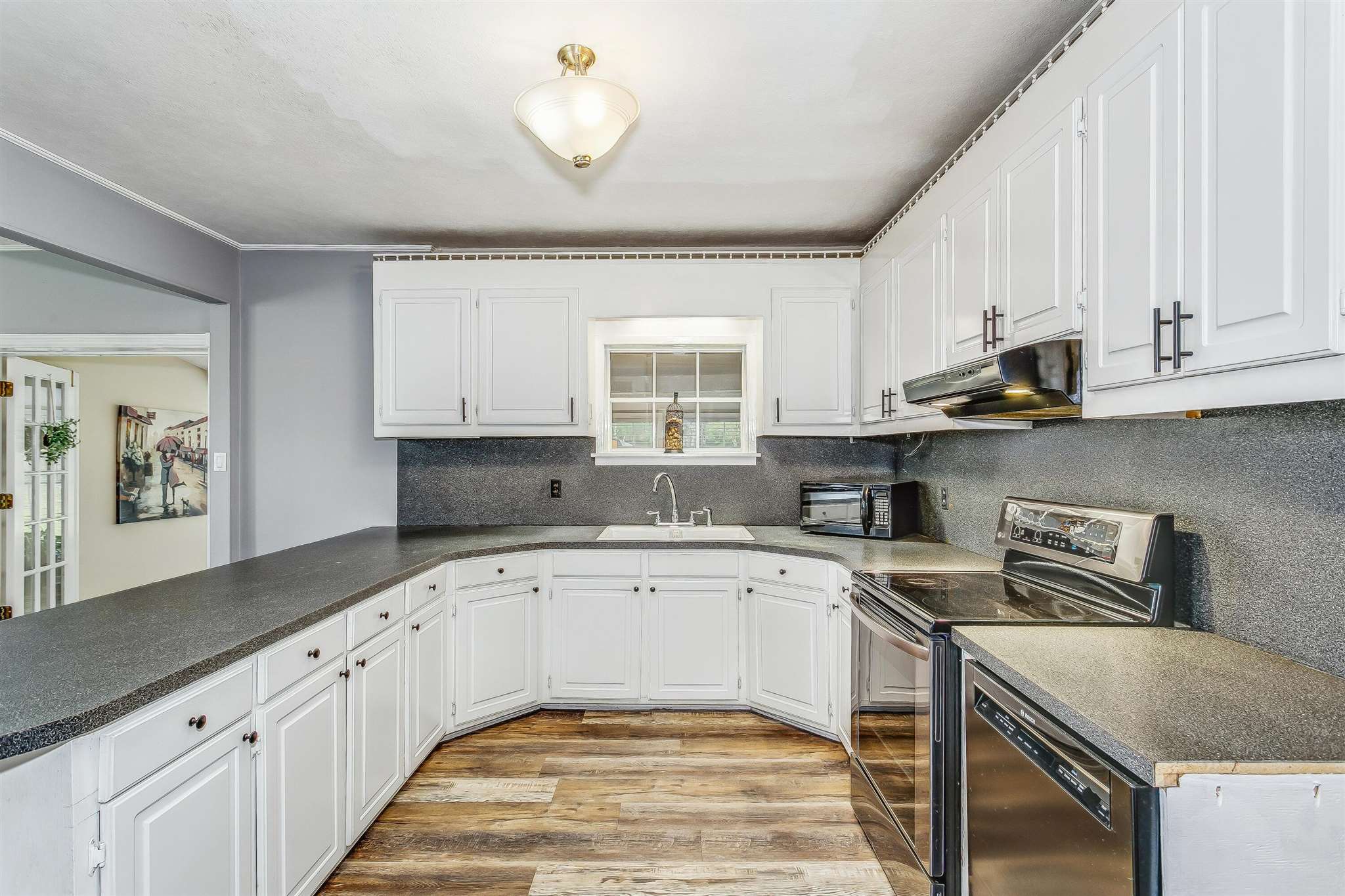 5926 Saufley Pines Road Pensacola, FL 32526 - Photo 10 of 35 a kitchen with a sink stove and cabinets