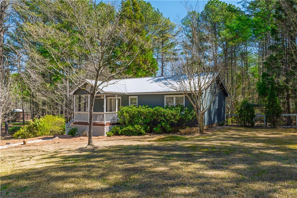 875 Yellow Creek Road Ball Ground, GA 30107 - Photo 1 of 1 a front view of a house with a garden
