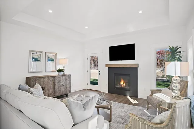 a living room with furniture a fireplace and a flat screen tv