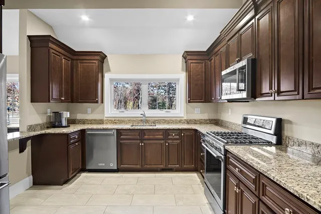 a living room with furniture a flat screen tv and a large window