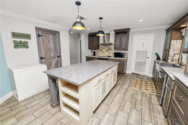 a kitchen with stainless steel appliances granite countertop a sink a stove a refrigerator and cabinets