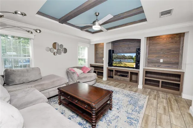 a living room with fireplace furniture and a flat screen tv