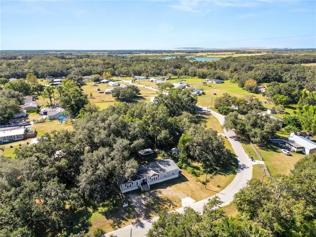 a view of a house with a yard covered with snow in the background