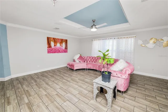 a living room with furniture and wooden floor